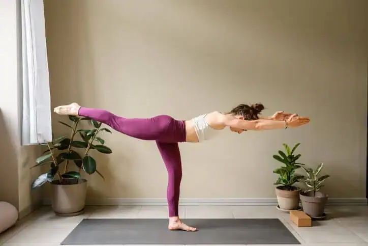 Woman doing Yoga exercise Feltham to help with toning the body. 